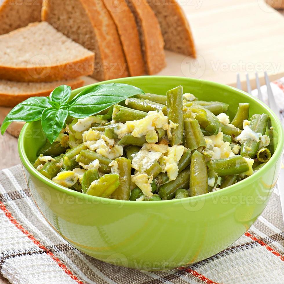 String beans with eggs in bowl. photo