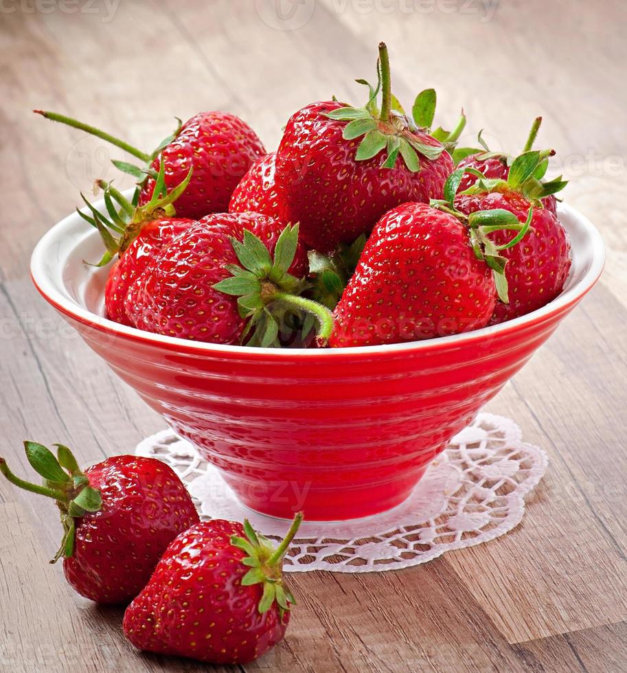 Close up of strawberry on wooden background photo