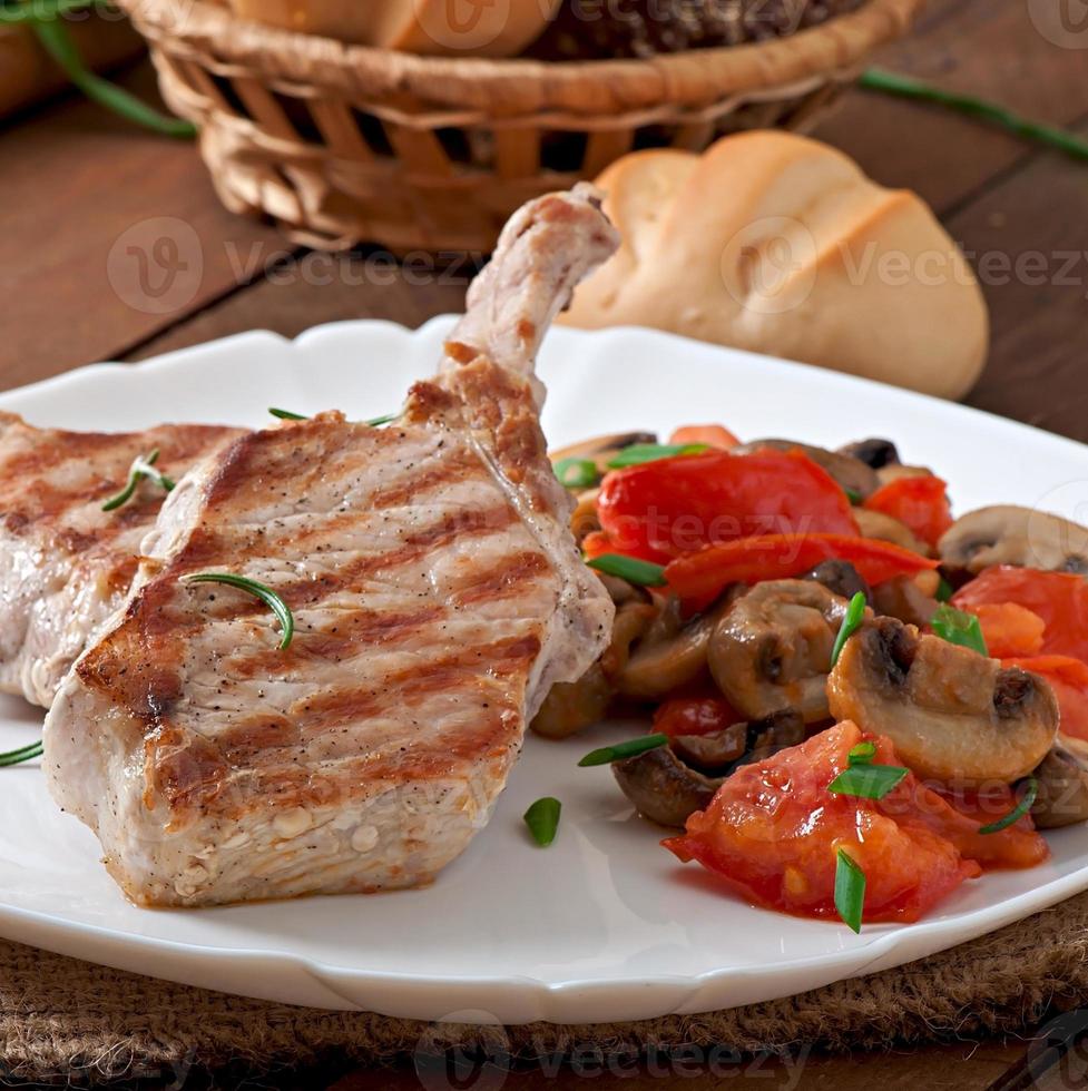 Juicy grilled pork steak on the bone photo