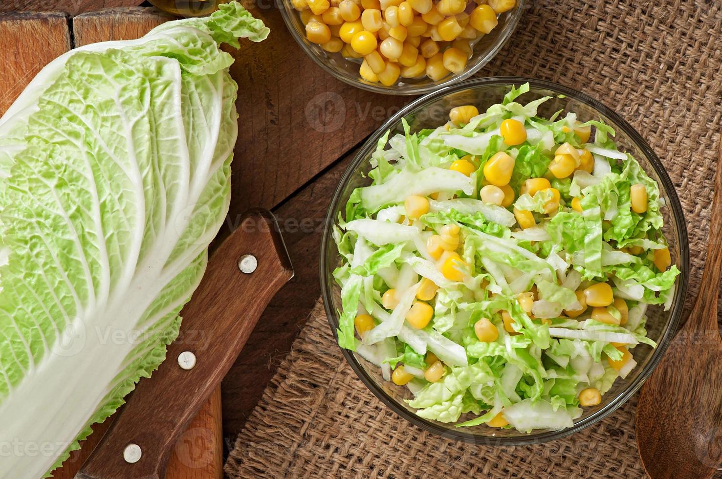 Chinese cabbage salad with sweet corn in a glass bowl photo