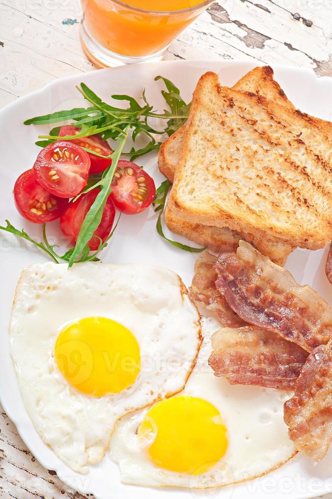 English breakfast - toast, egg, bacon and vegetables photo