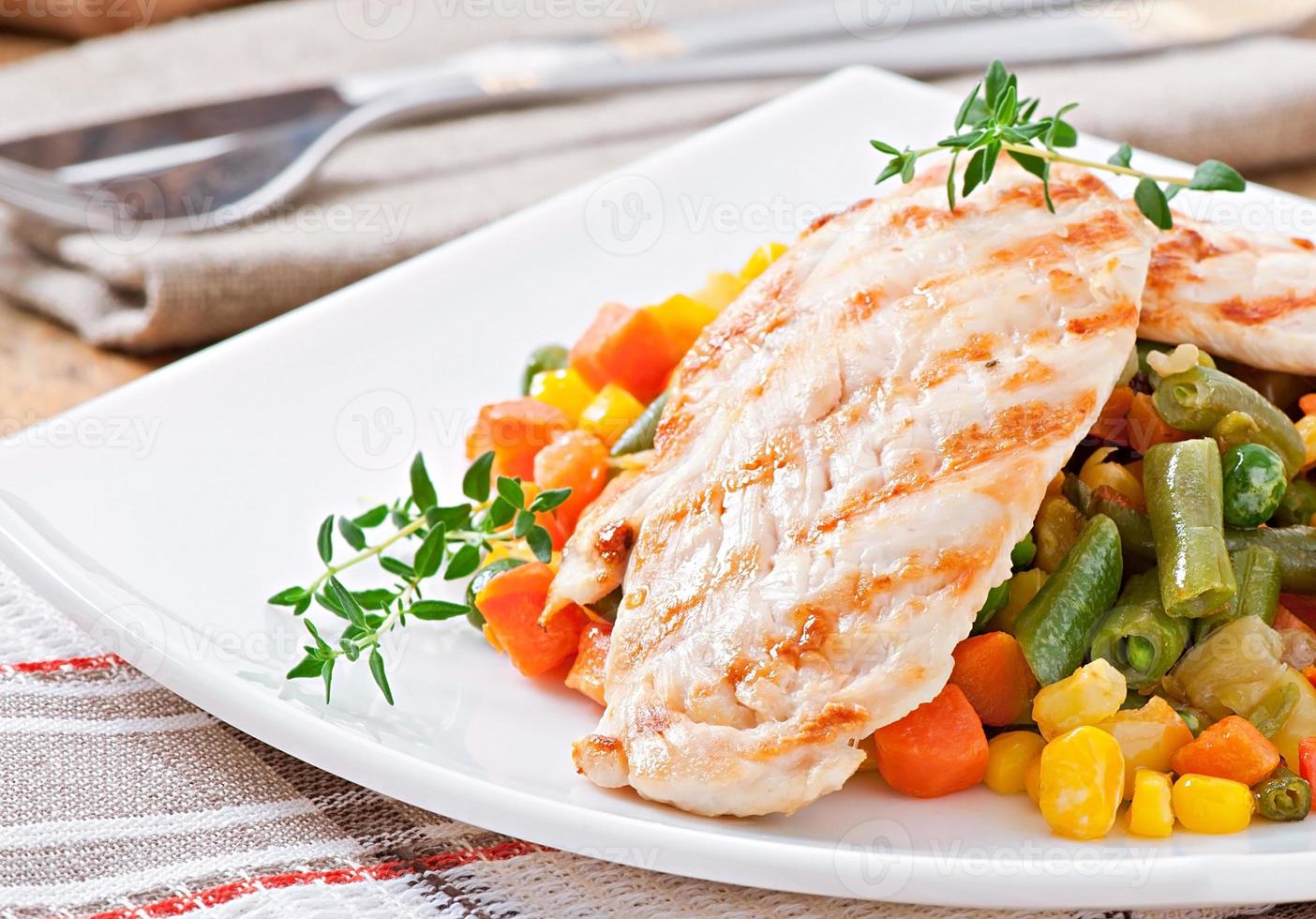 Grilled chicken breasts and vegetables photo