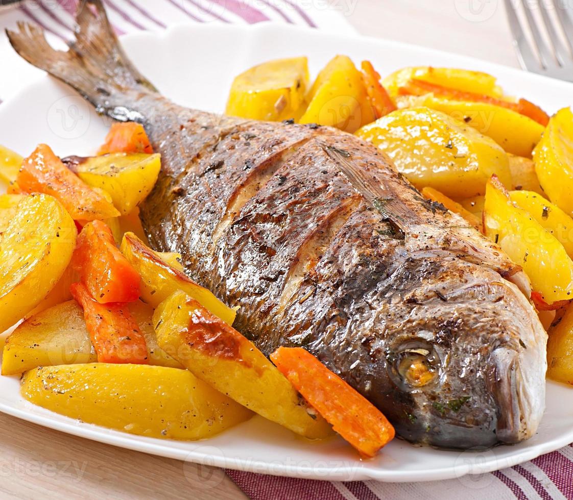 Dorada baked with potatoes photo