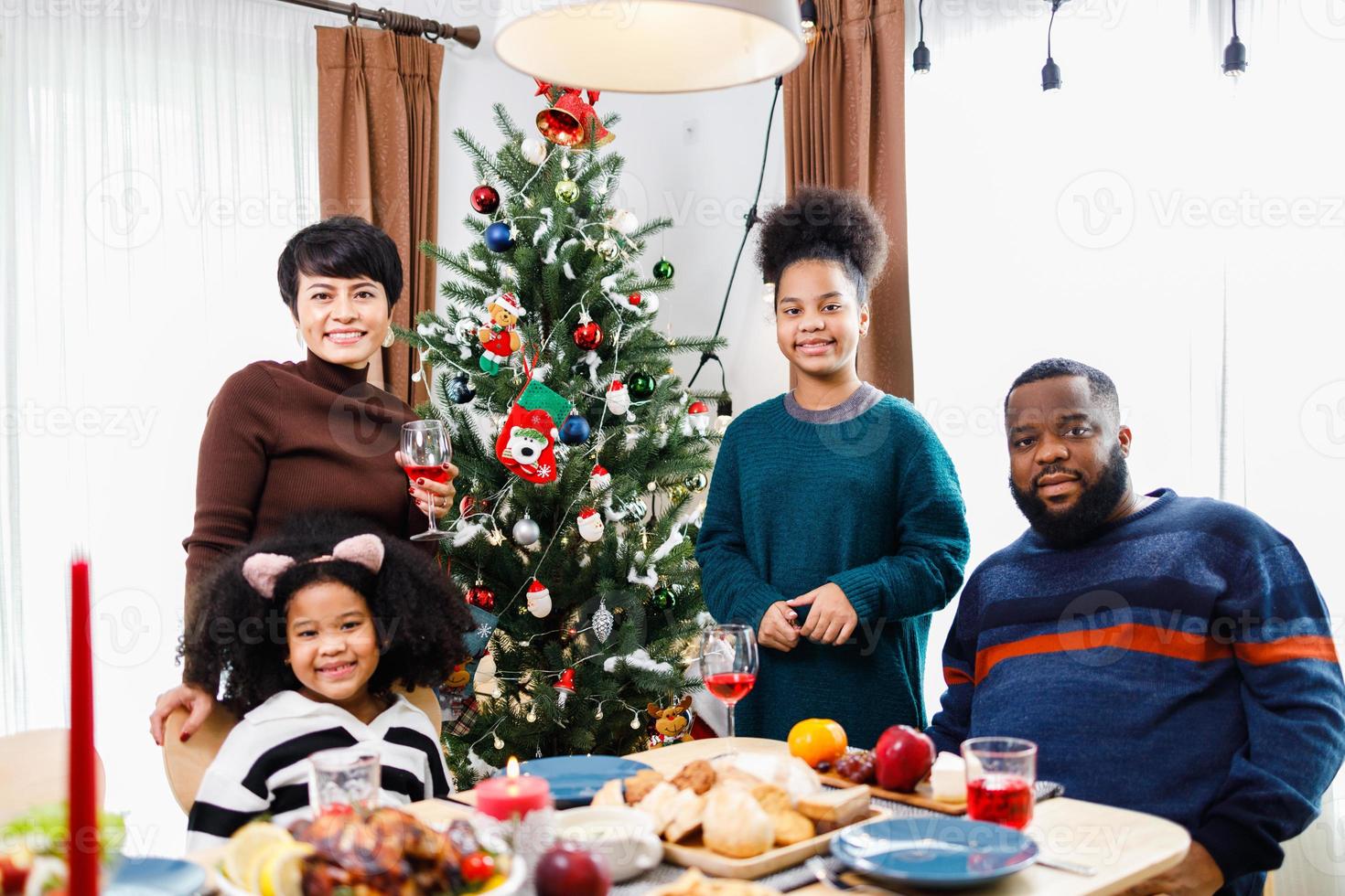 African American family. Merry Christmas. Happy family are having dinner at home. photo