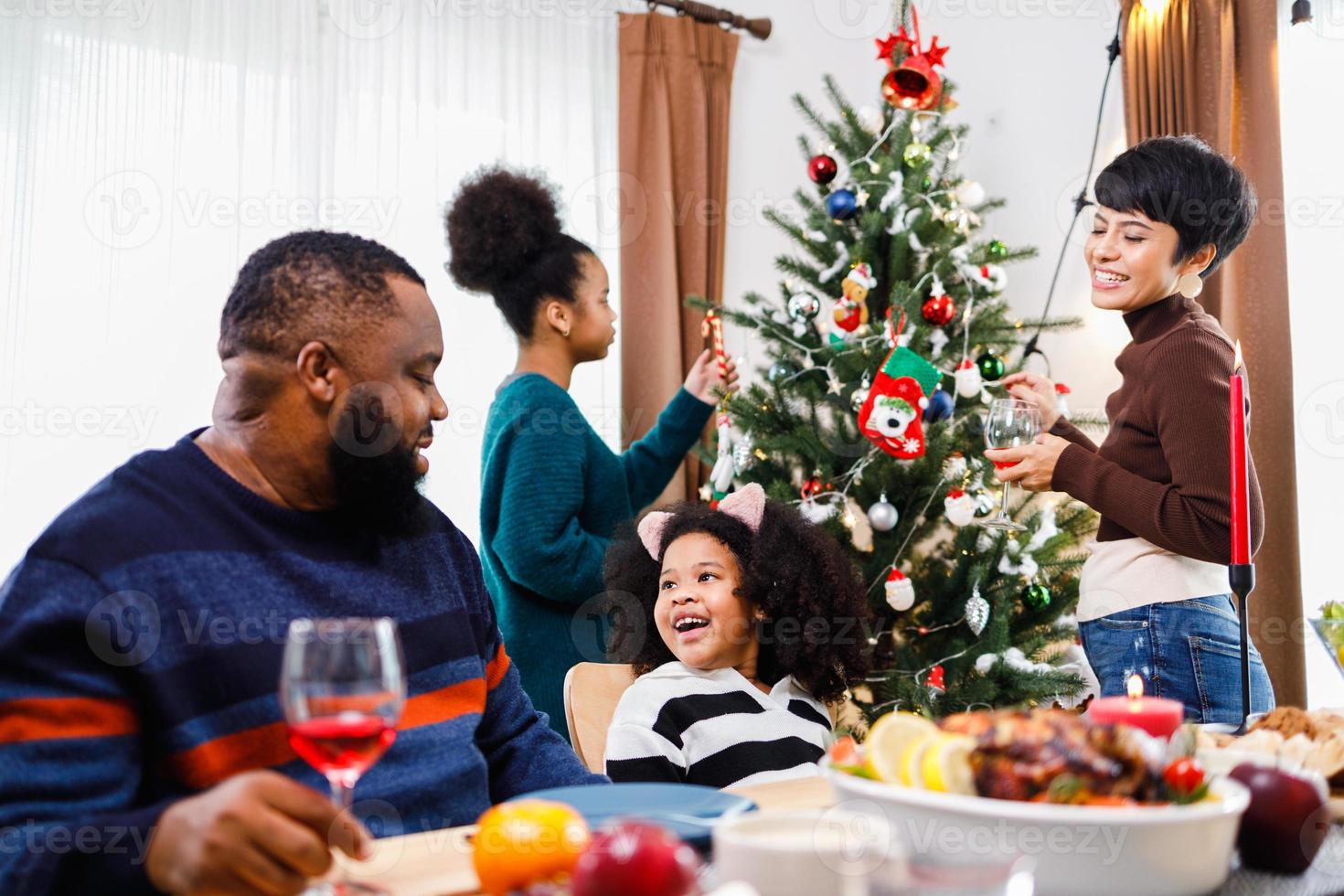 African American family. Merry Christmas. Happy family are having dinner at home. photo