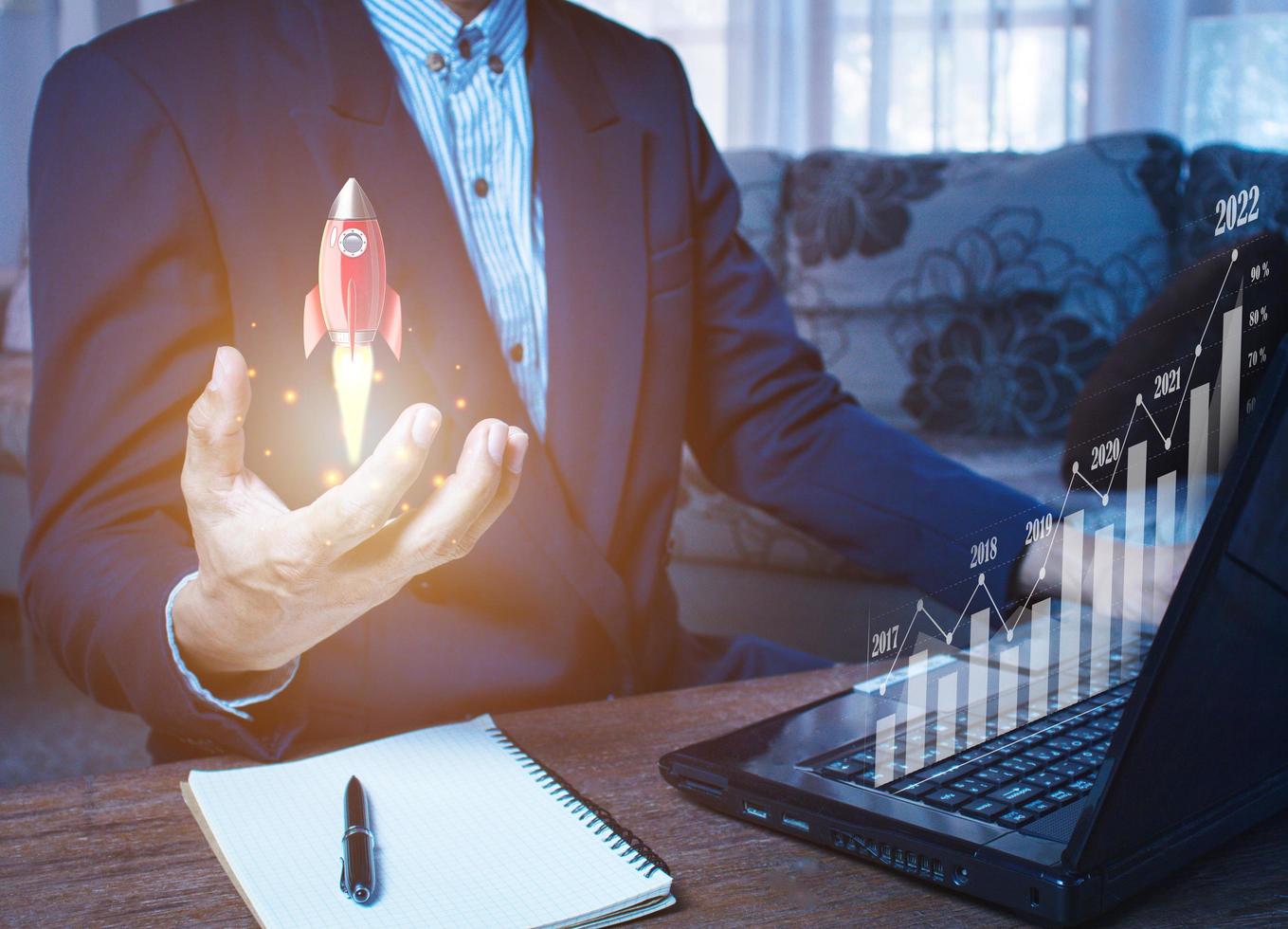 hombre de negocios sosteniendo y mostrando un creciente holograma virtual de estadísticas, gráficos y gráficos con flecha hacia arriba foto