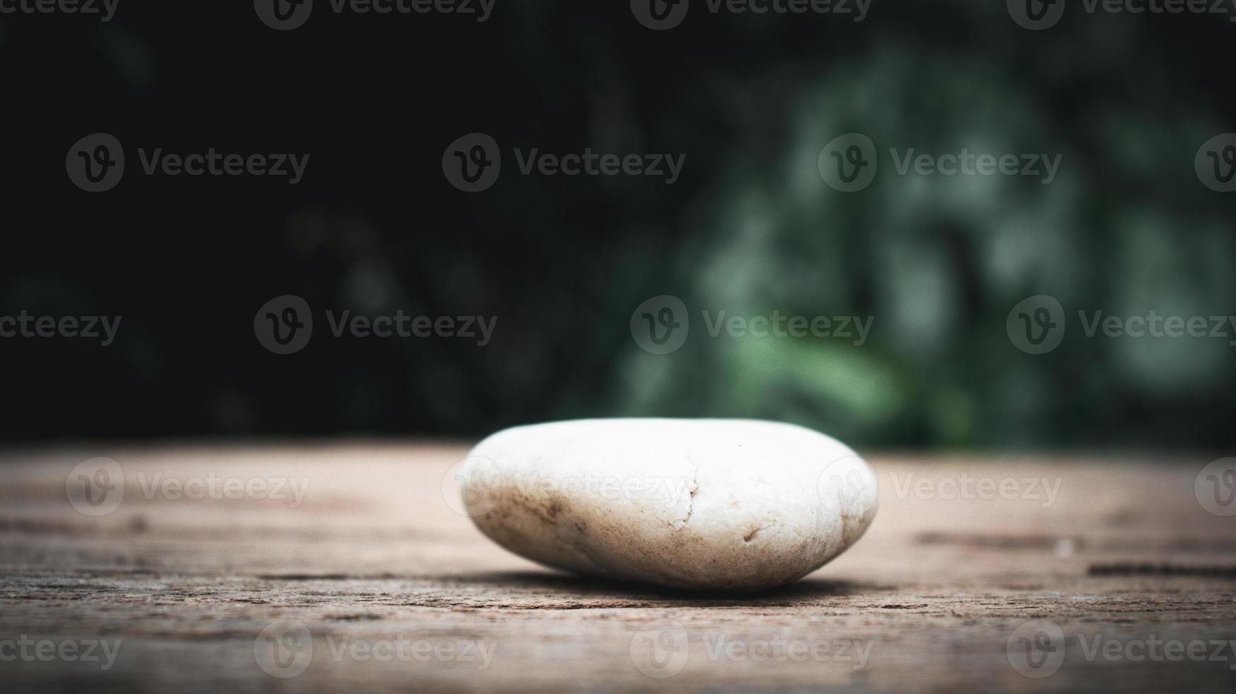 White rocks on old wooden planks photo