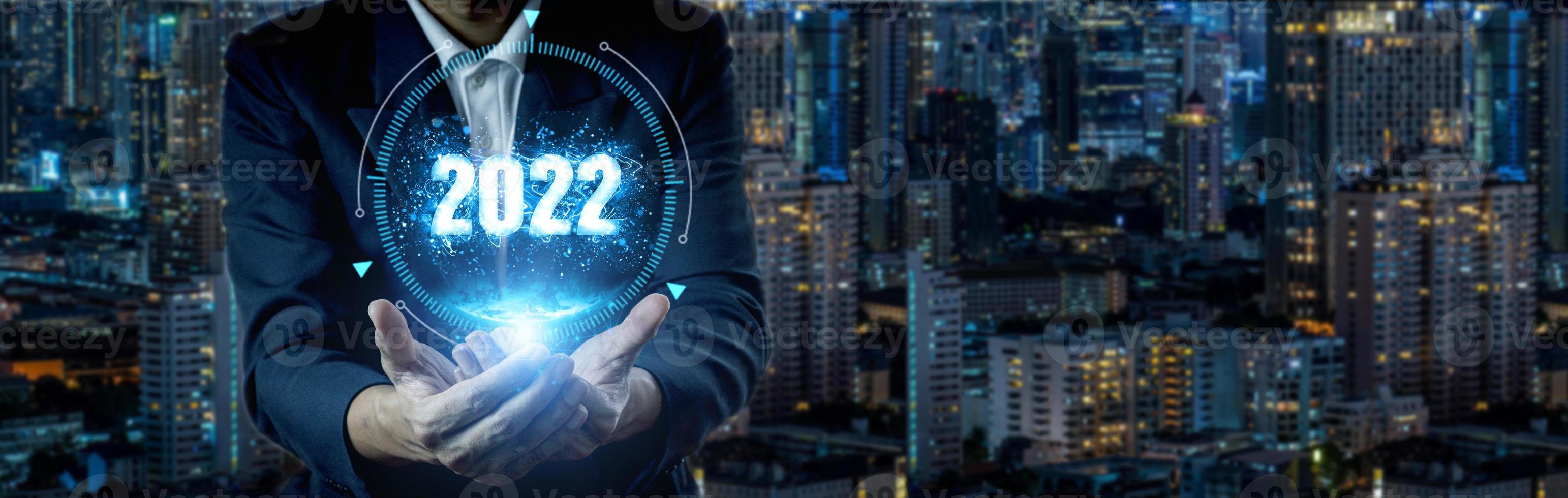 Businessman holding 2022 virtual number photo