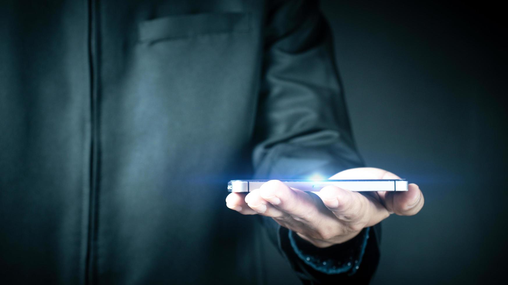 Businessman holds smartphone business internet . photo