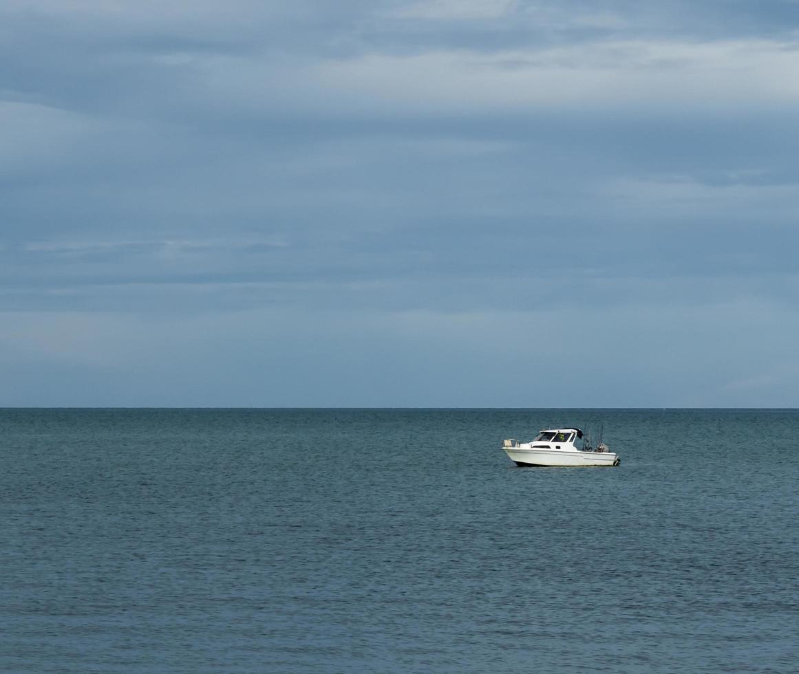white boat in the sea photo