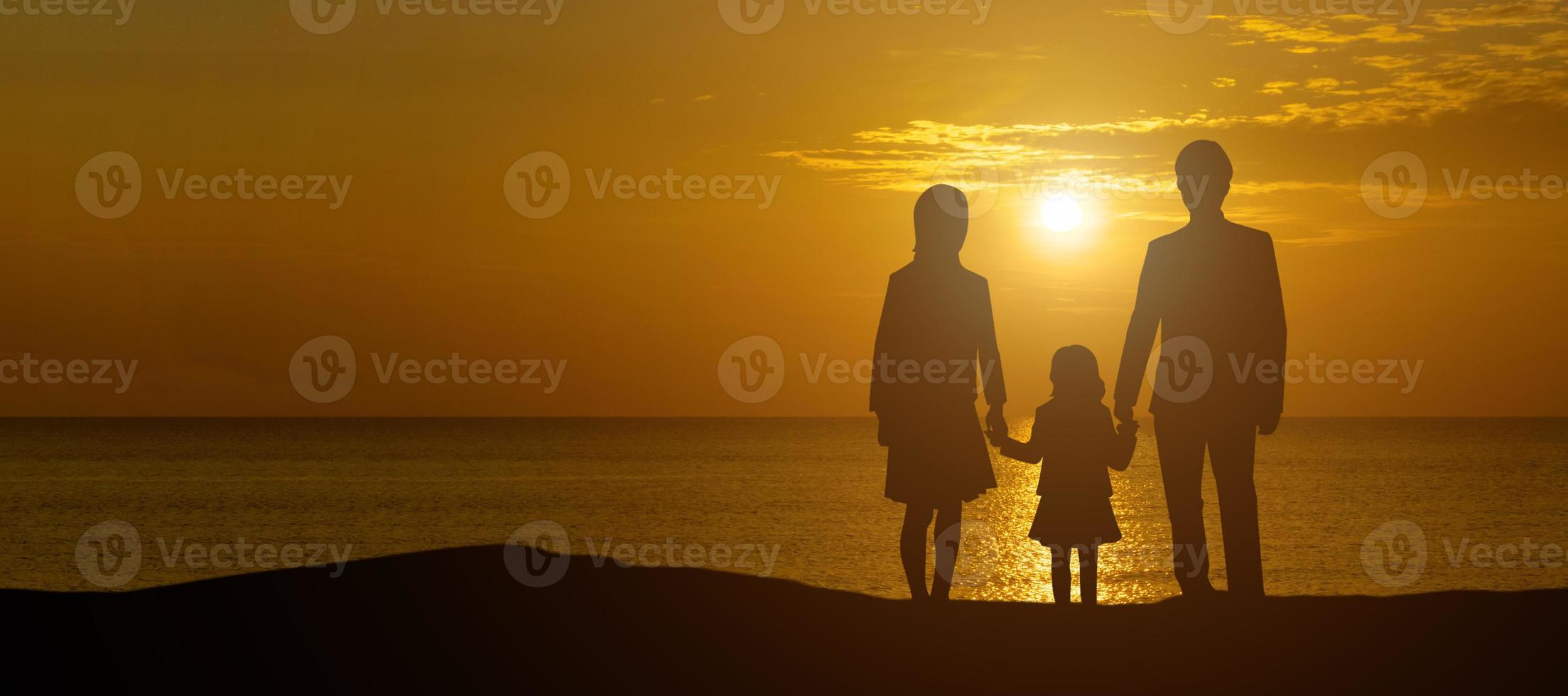 A panoramic view of the family silhouette overlooking a serene sunset . photo