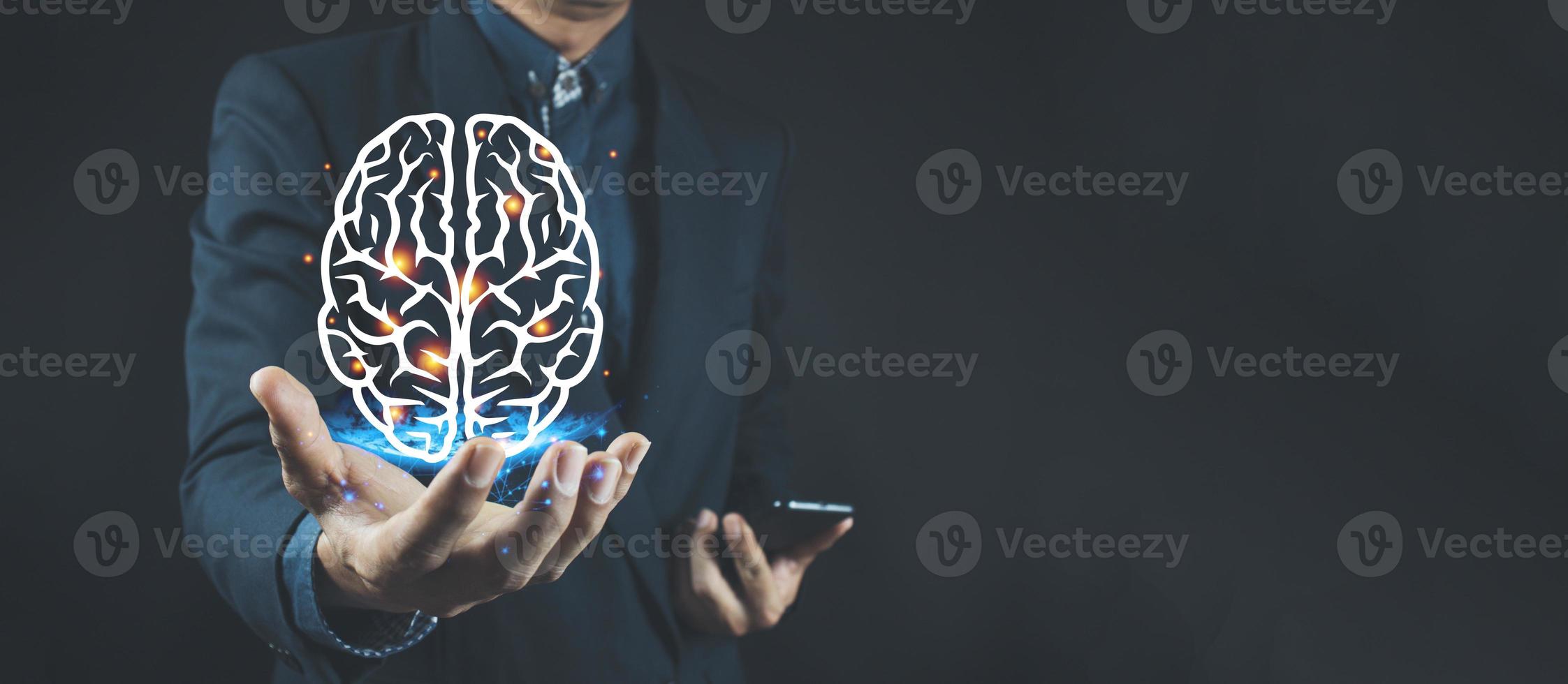 Businessman holding digital image of brain in palm photo