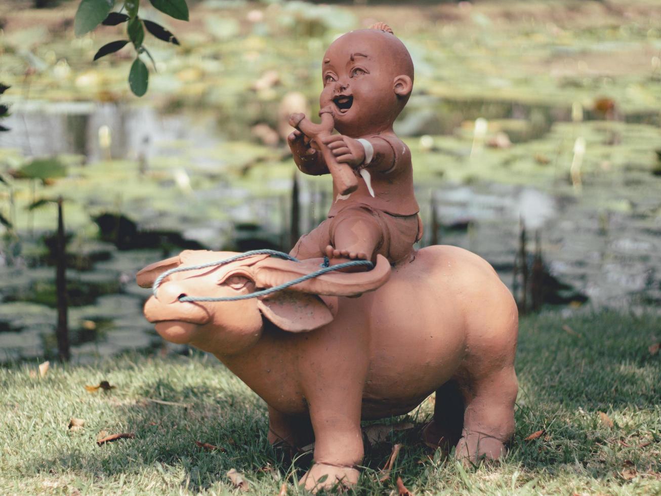 Statues of children playing in the garden . photo