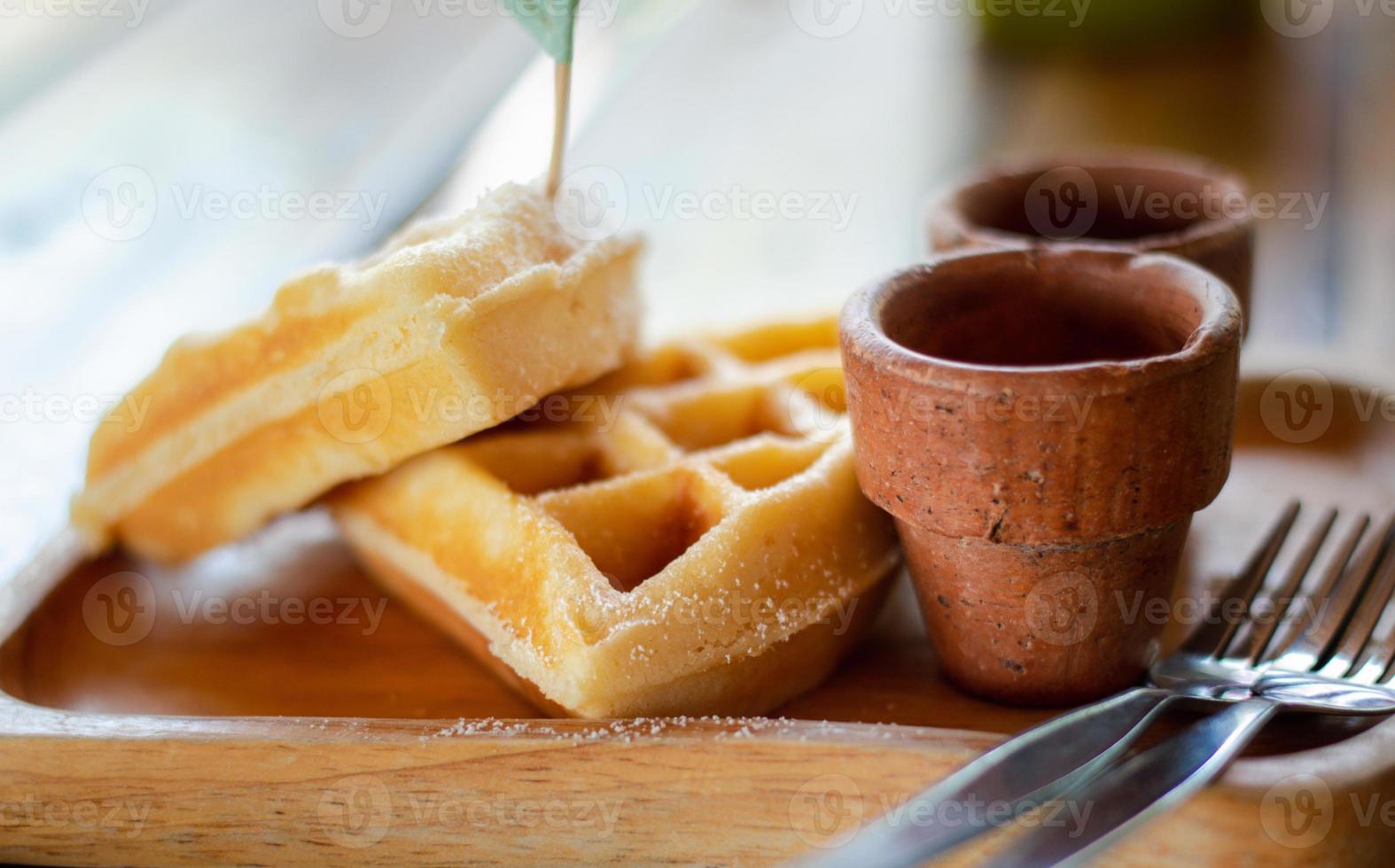 Homemade Belgium waffles served on a plate. photo