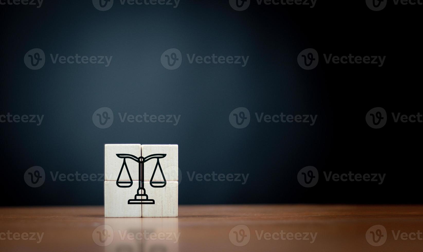 law flat icon on cube block on wooden table over dark background . photo