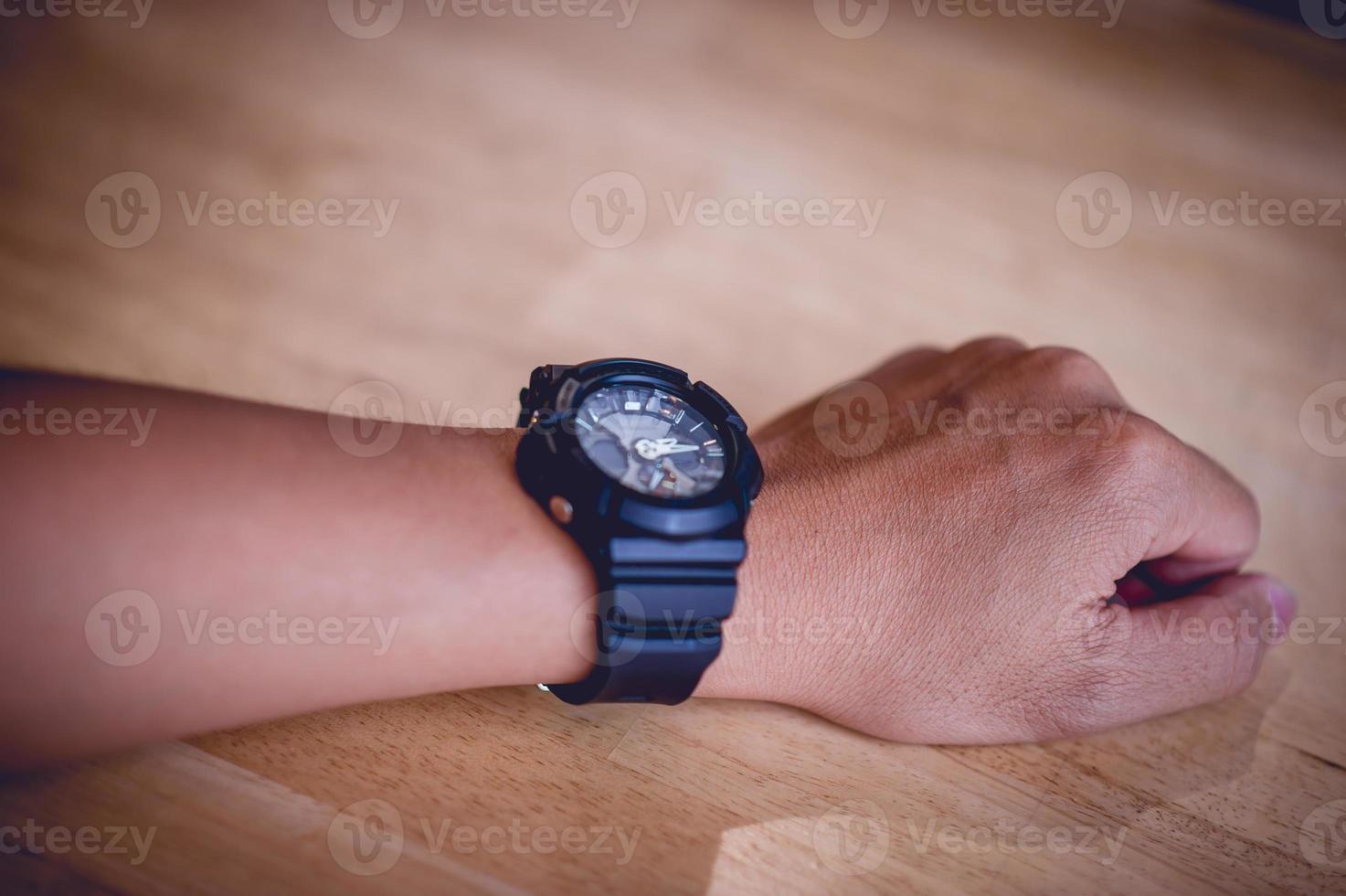 Hands and men's black wrist watches, punctuality concepts photo