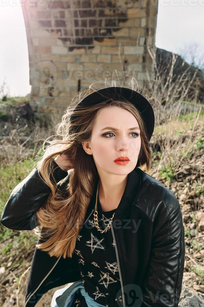 Stylish hipster woman traveler by the old bridge viaduct. Traveling, Europe, fashion, style concept photo