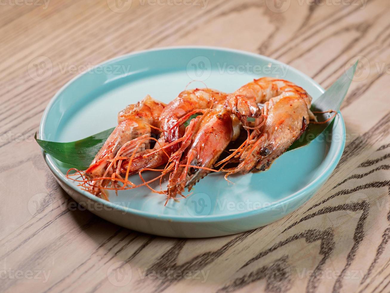 shrimp on the plate on the table in the bar photo