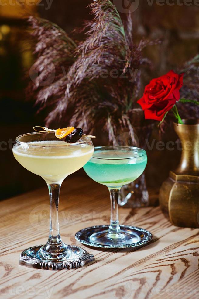 different colorful alcohol and non-alcohol cocktails in the glasses on the table photo