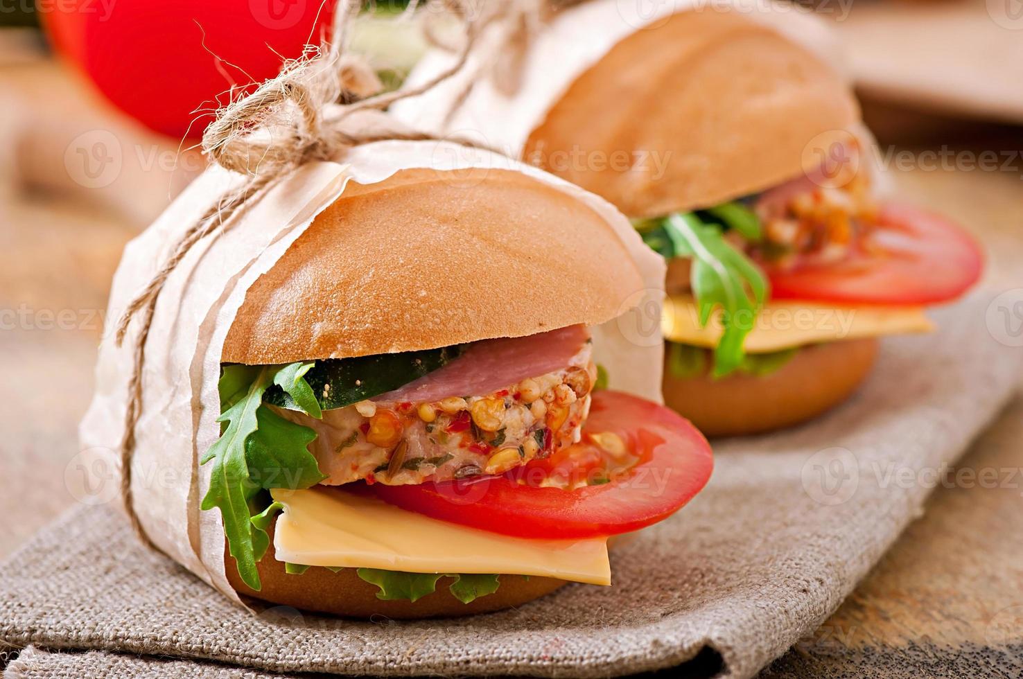 Sandwich with ham, cheese and fresh vegetables photo