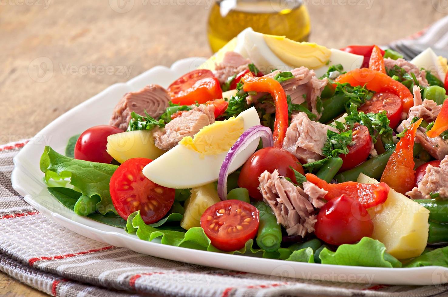 Salad with tuna, tomatoes, potato and onion photo