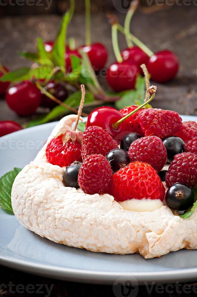 Cake  Pavlova with cream and berries photo