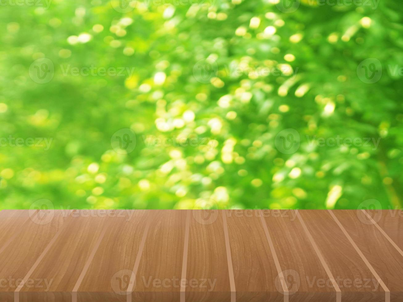 Brown wooden table on blurred greenery nature background, Natural template Foliage green leaves texture backlight bokeh sunshine for display product photo