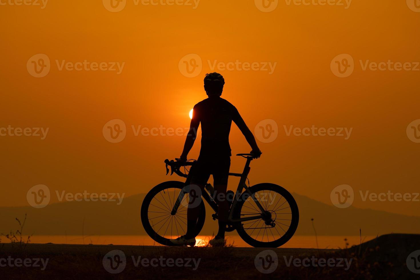 Silhouette of a cyclist on sunset in Thailand. photo