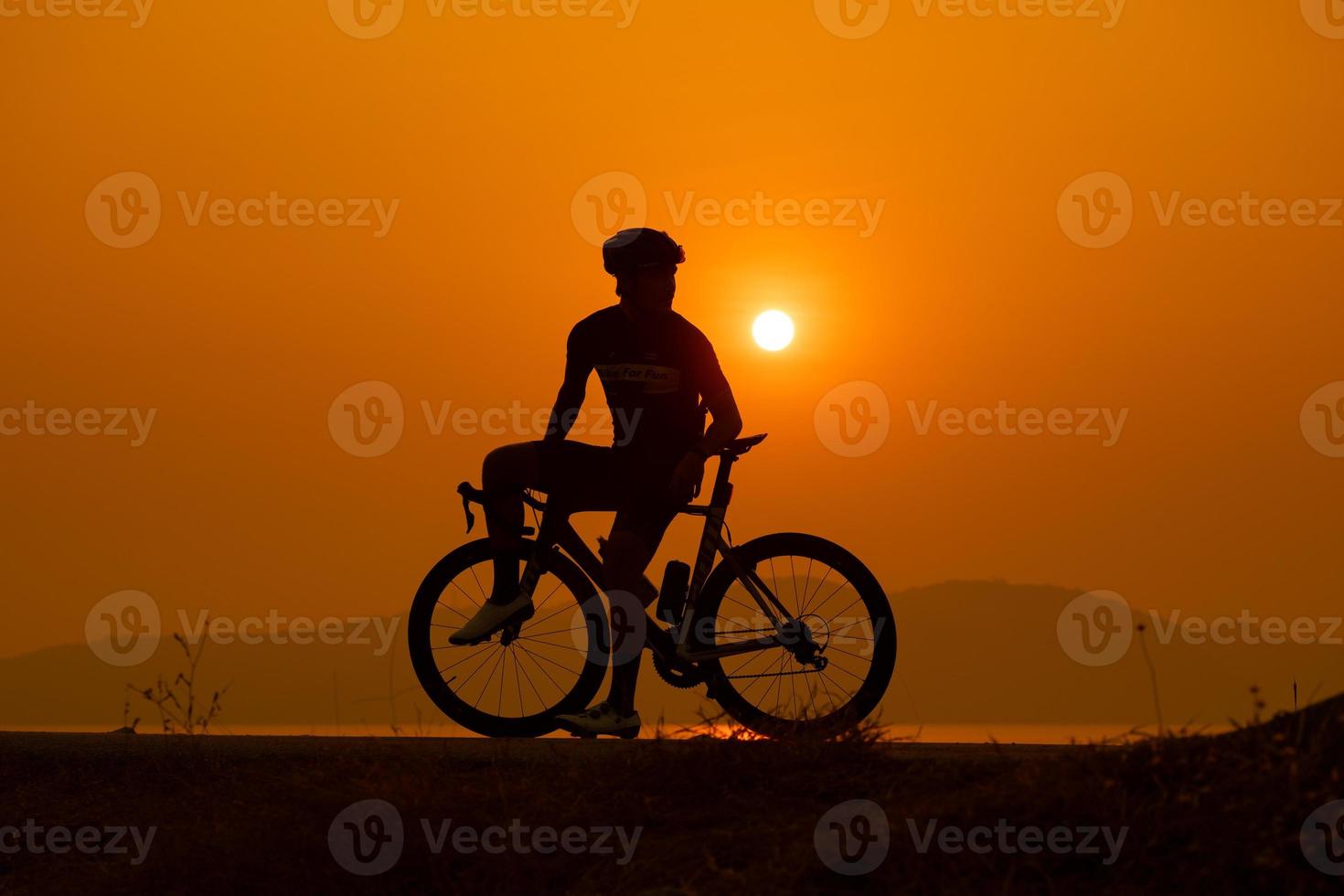 Silhouette of a cyclist on sunset in Thailand. photo