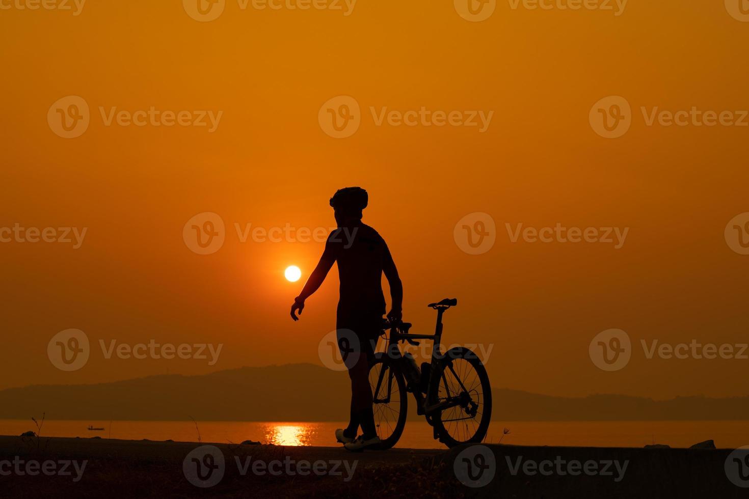 Silhouette of a cyclist on sunset in Thailand. photo