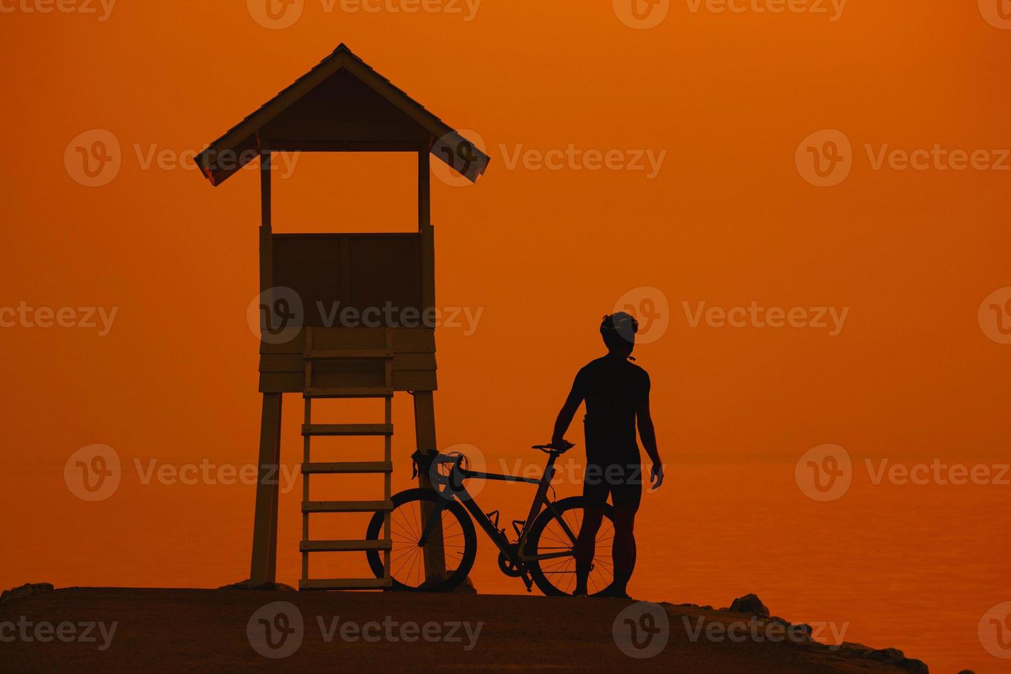 Silhouette of a cyclist man on sunset in Thailand. photo