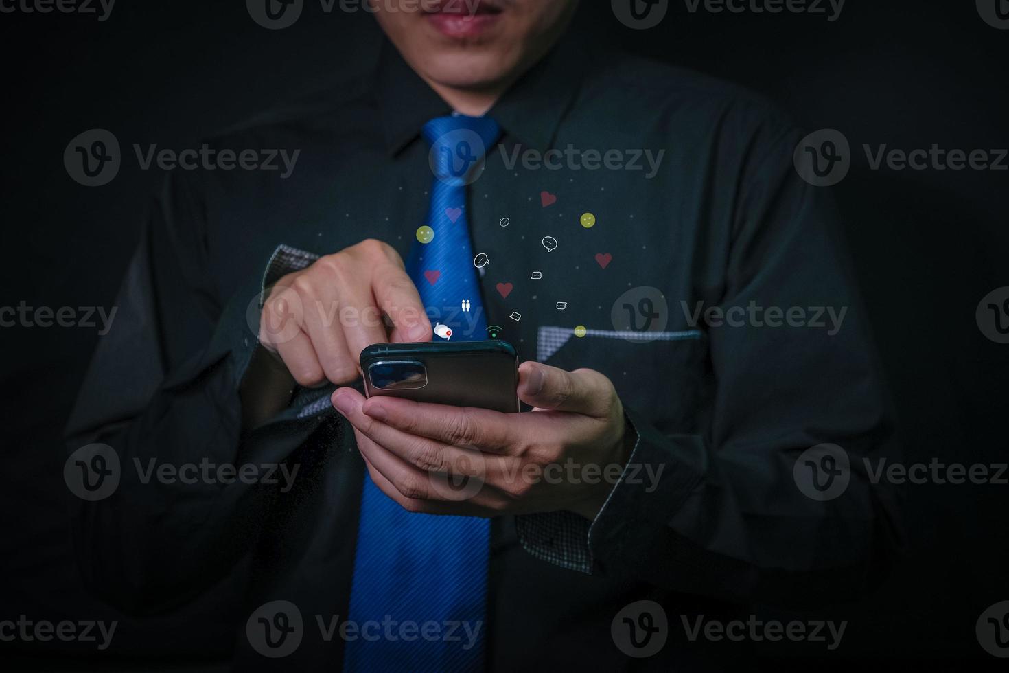 Businessman in a black suit communicates with a virtual digital phone screen online. photo