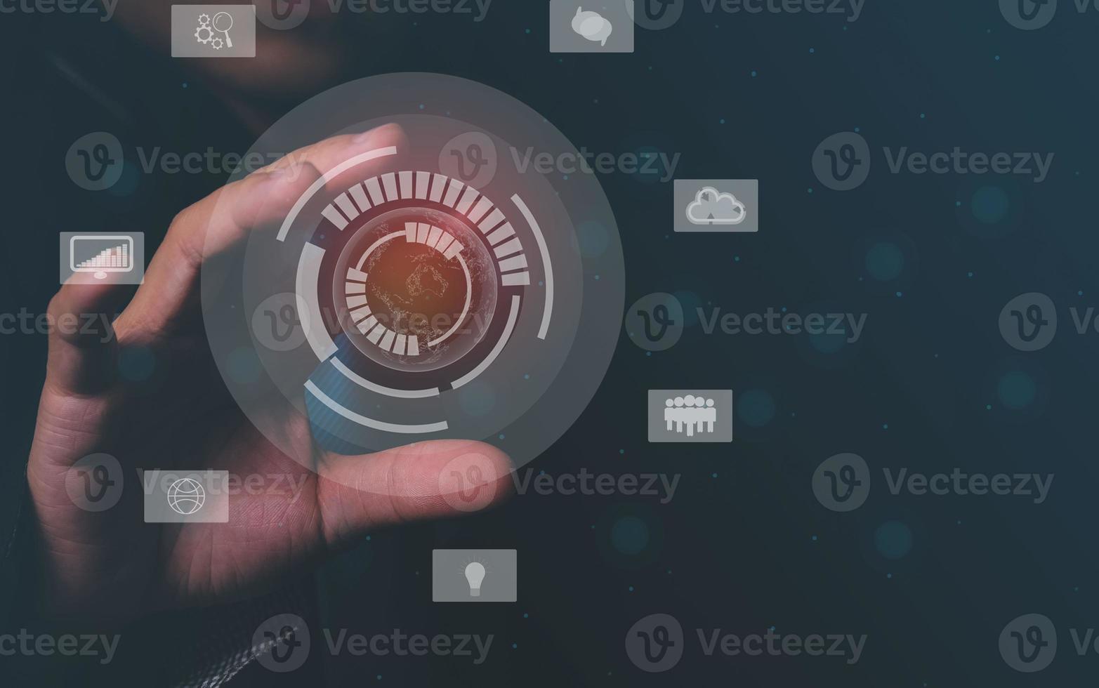 Businessman in black communicating with virtual digital screens around the world on high-speed online network. photo