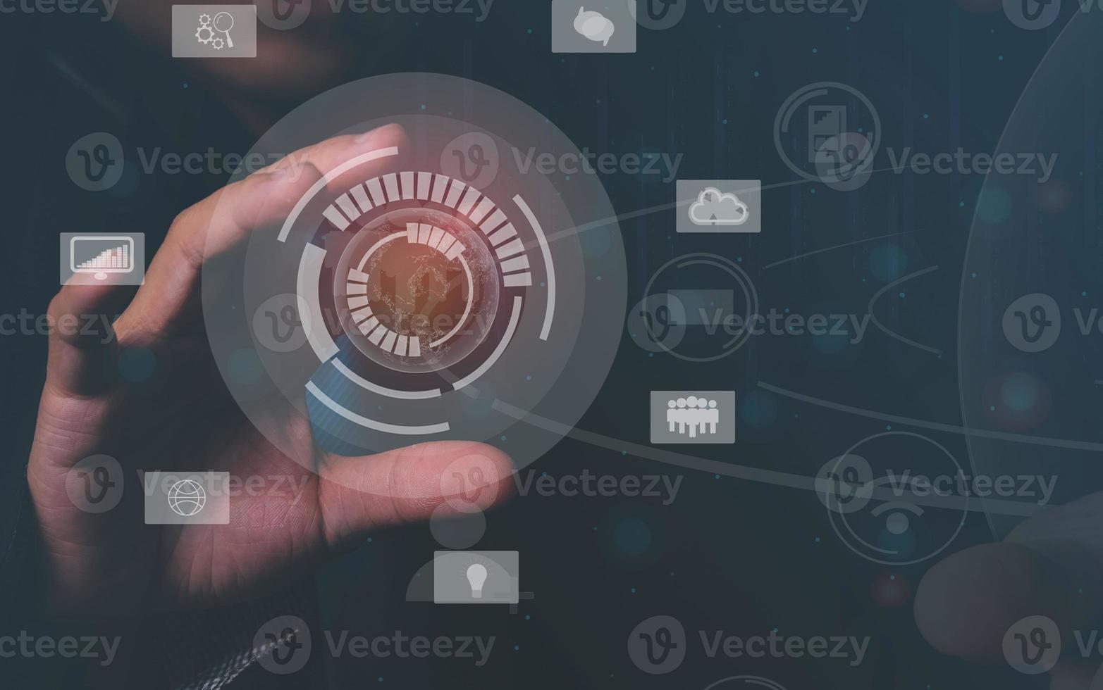 Businessman in black communicating with virtual digital screens around the world on high-speed online network. photo