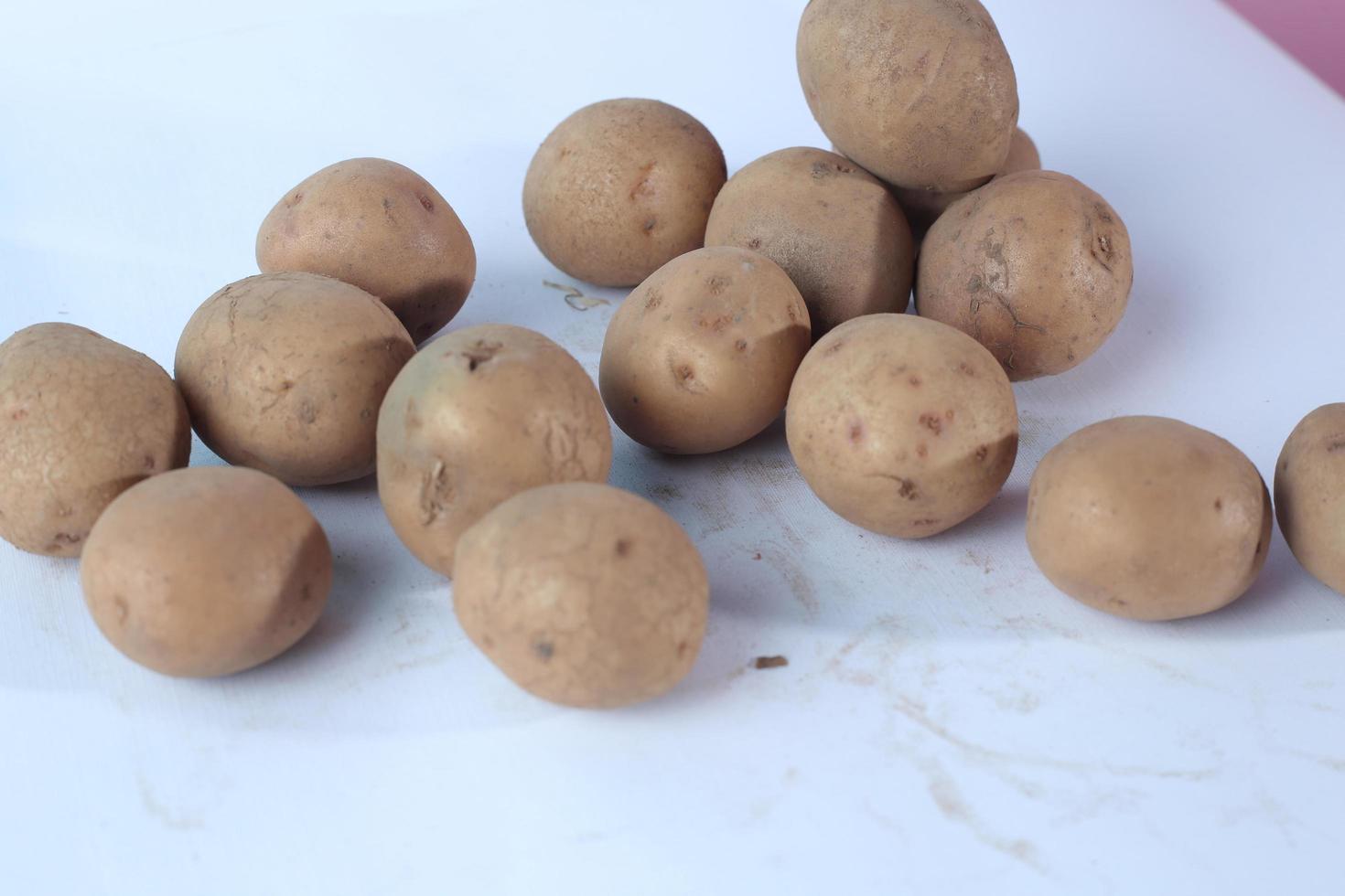 New potato isolated on white background close up photo