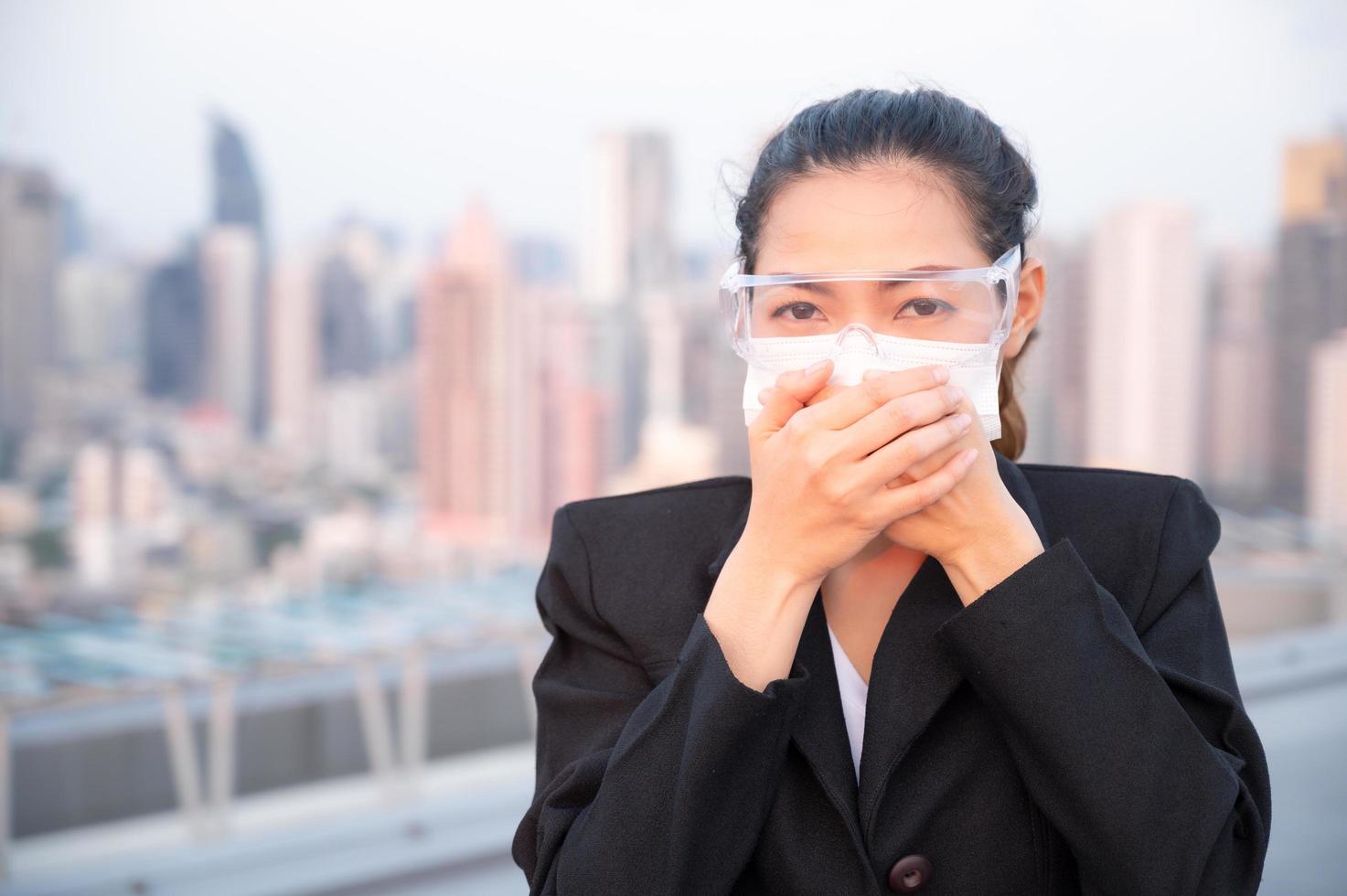 Asian women have to use masks and goggles to protect against pollution from dust and prevent the infection from viruses photo