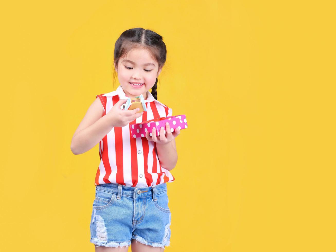 A lovely girl is enjoying the opening of a family gift box for Christmas and New Year's Eve photo