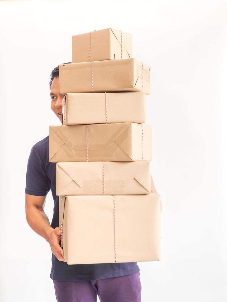 Young man carrying a box  of supplies to send a lot of customers carefully photo