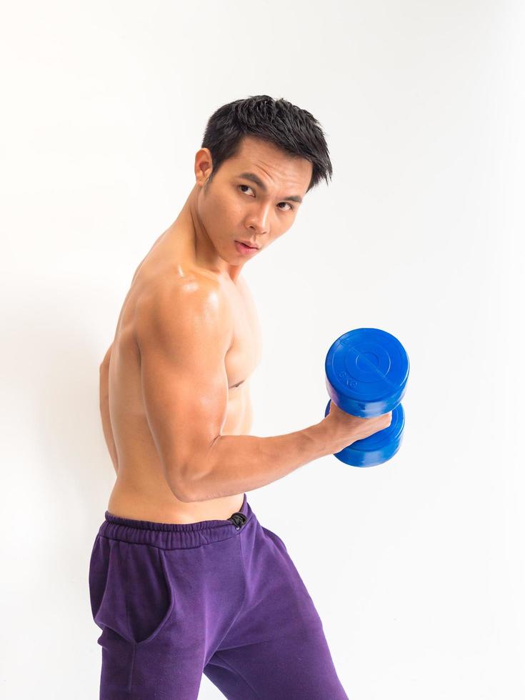 A strong young man with power to show strong and beautiful muscles photo