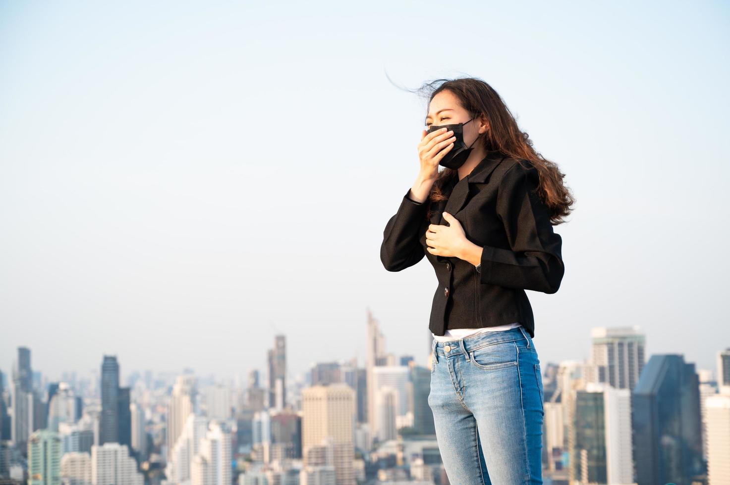 Asian business women have to use a mask to cover the face to prevent pollution from dust photo