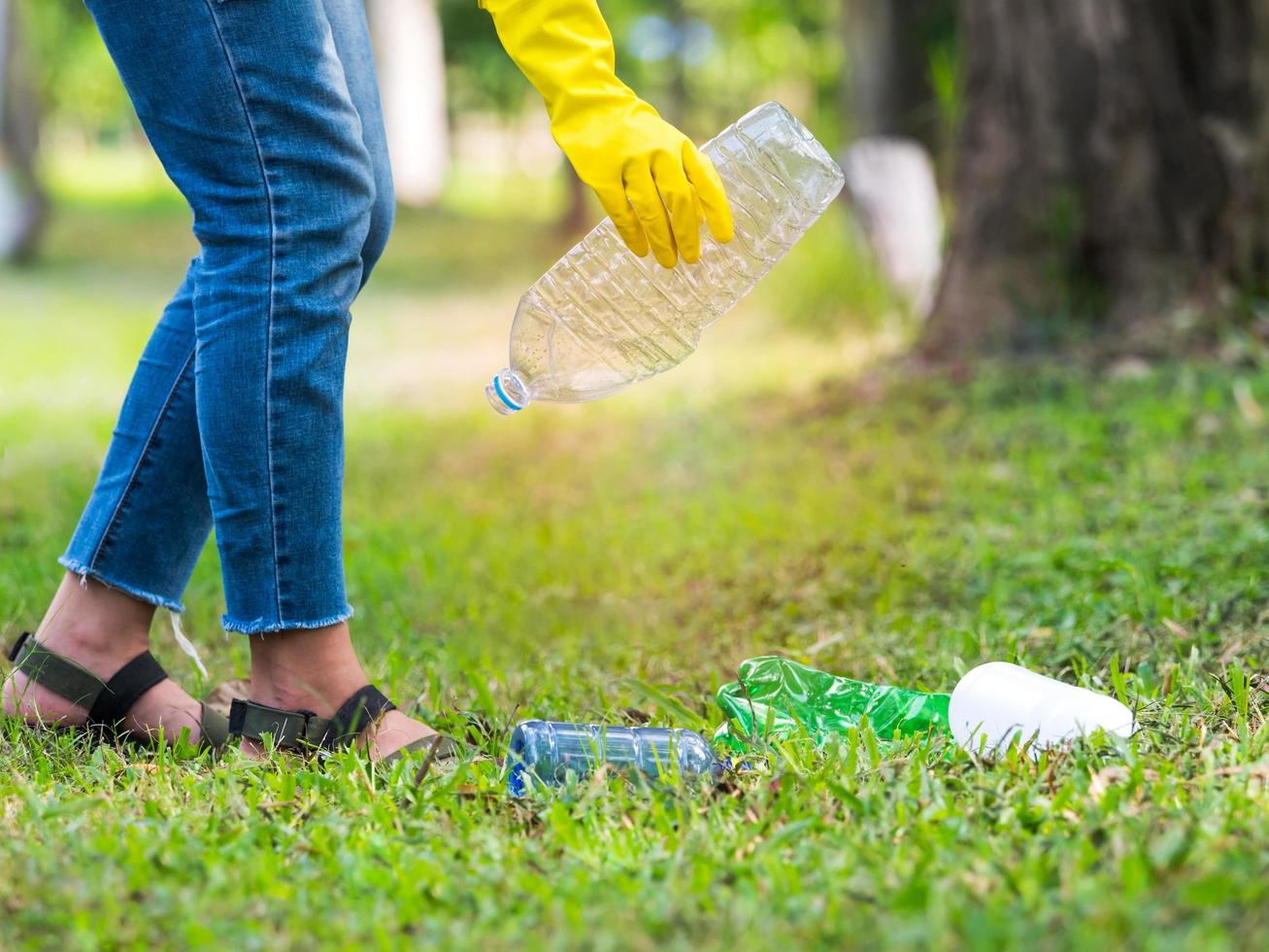 Volunteer women collect plastic water bottles in the park area, From people who refuse to throw in the trash photo