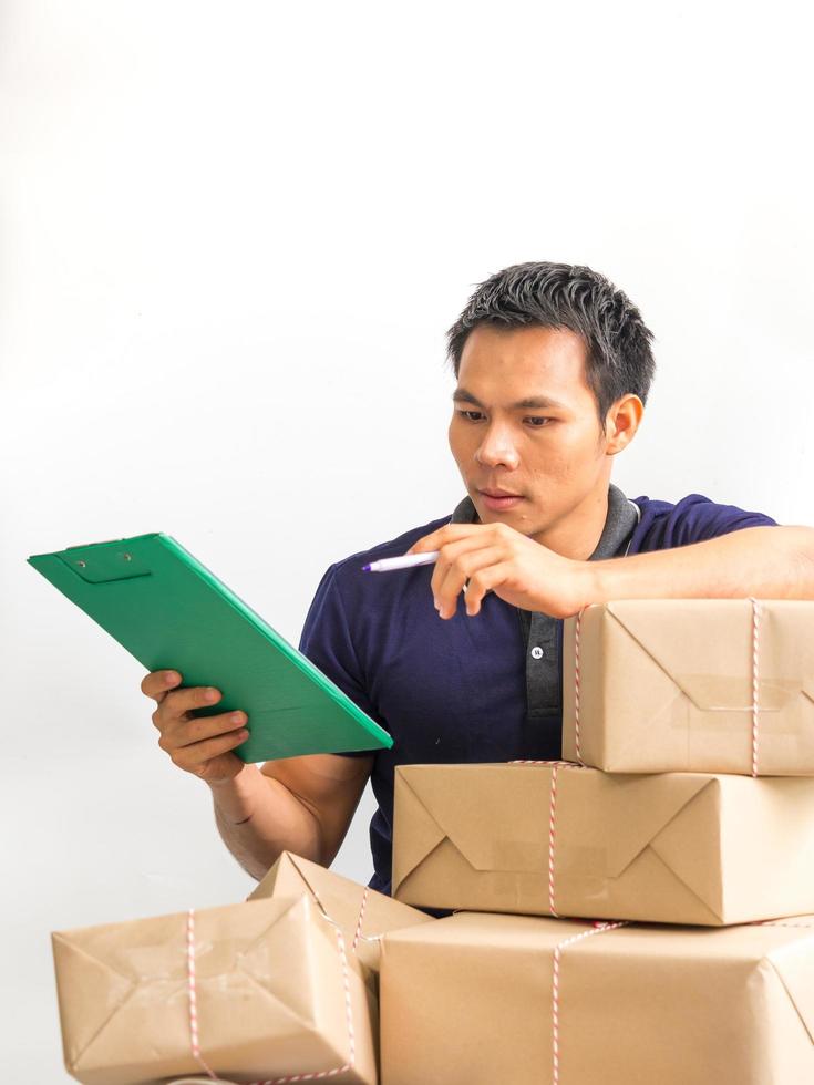 Young man checking a data  of supplies to send a lot of customers photo