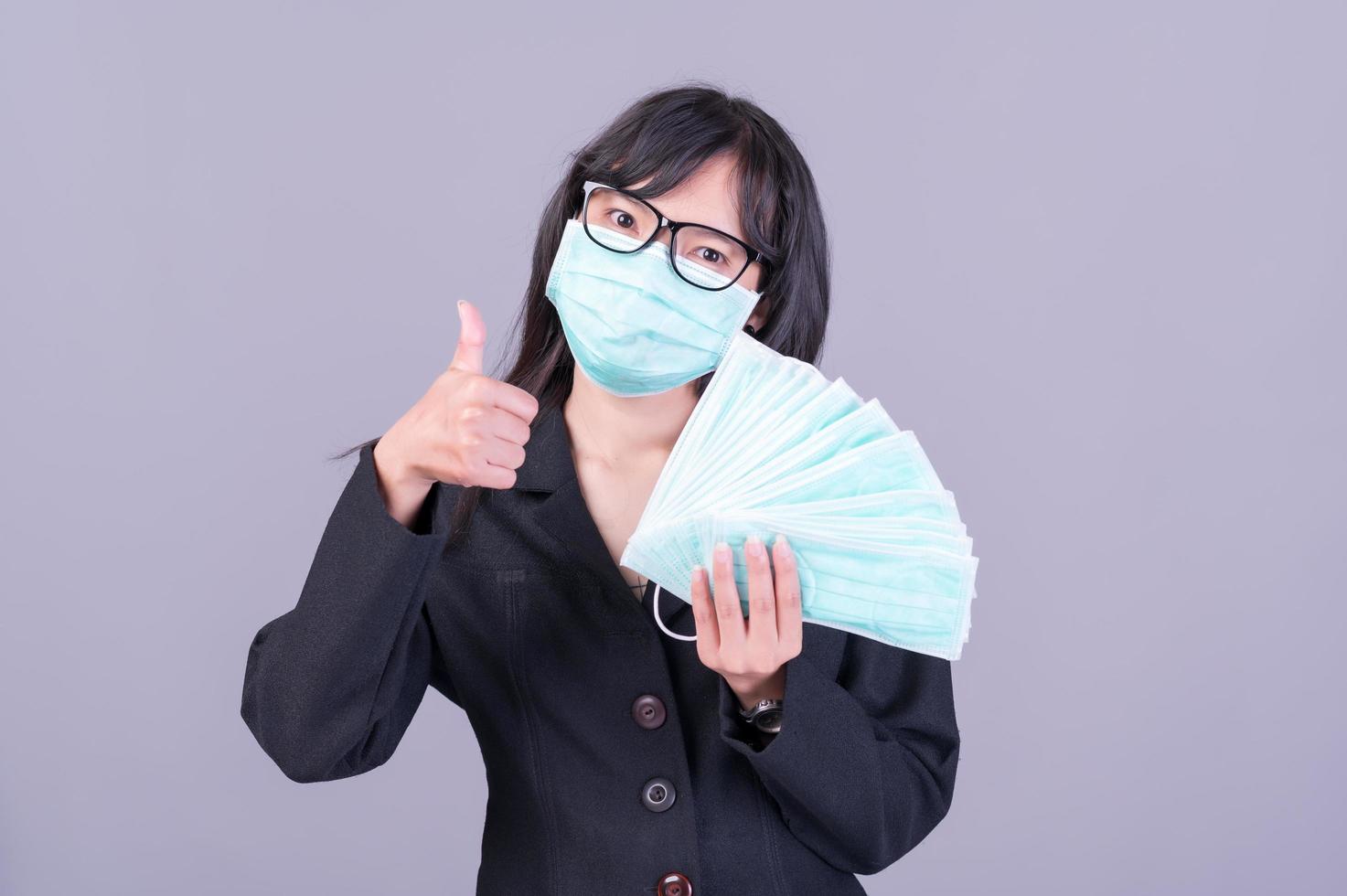 Asian business women have to use a mask to cover the face to prevent pollution from dust photo