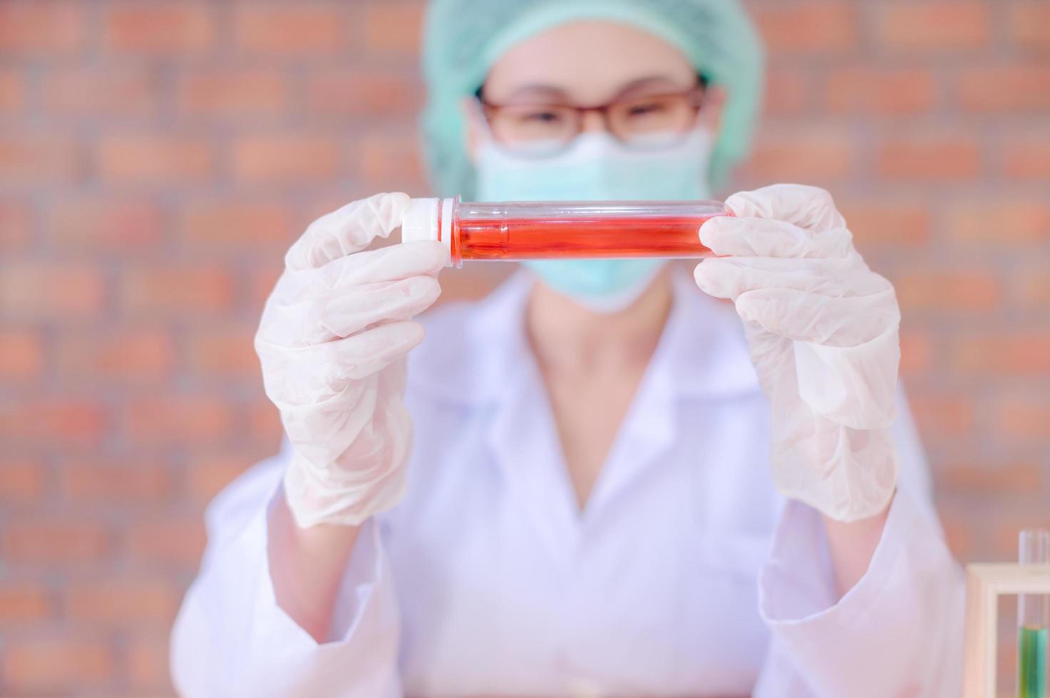 Asian female researchers are doing chemistry tests to analyze the drugs that will be used during the outbreak of the corona virus photo