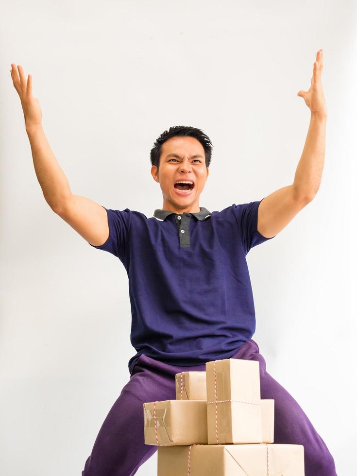 The young man lift his hand with joy in achieving the goal of wholesale products online for customers photo