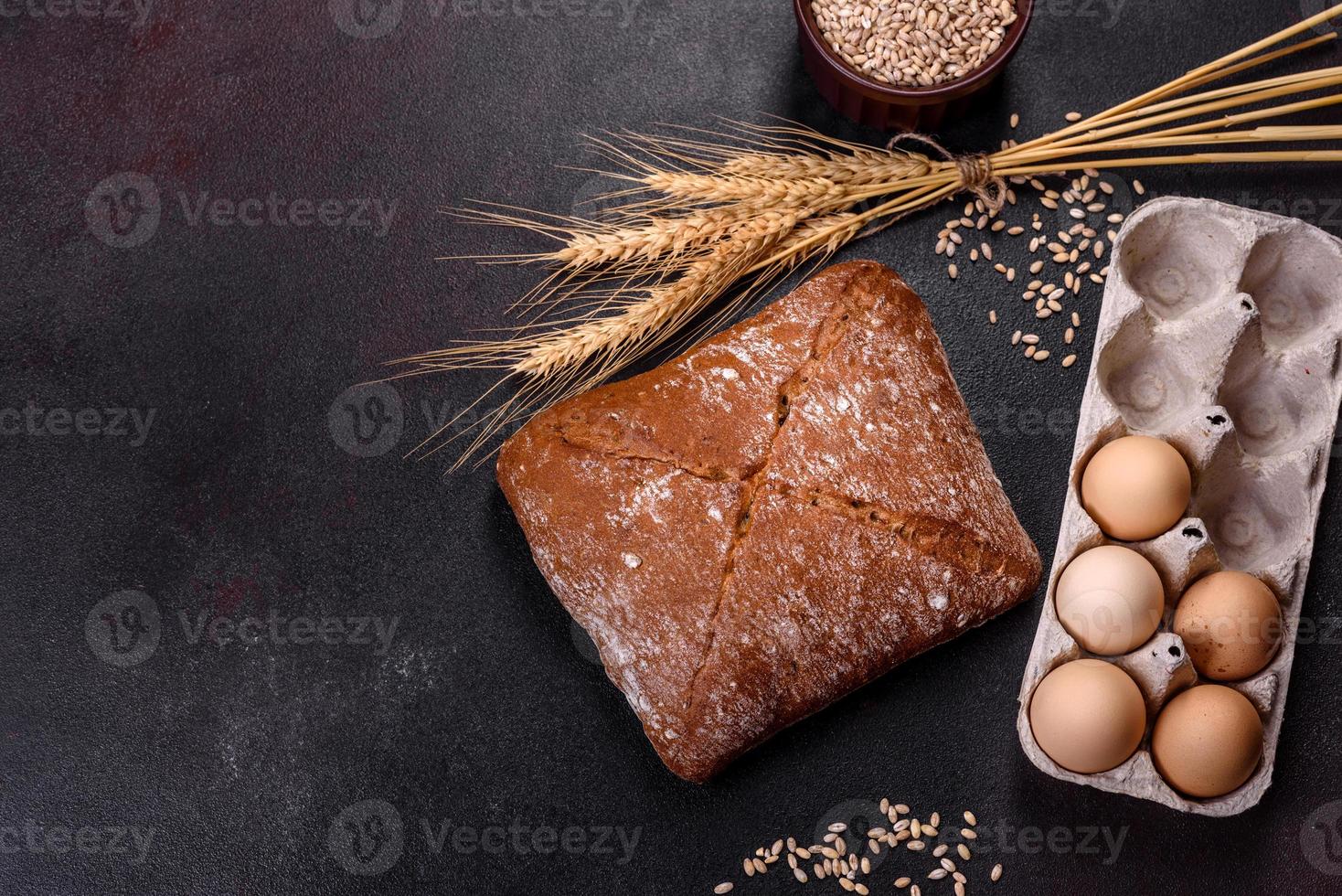 Beautiful tasty, square-shaped brown bread on a dark concrete background photo