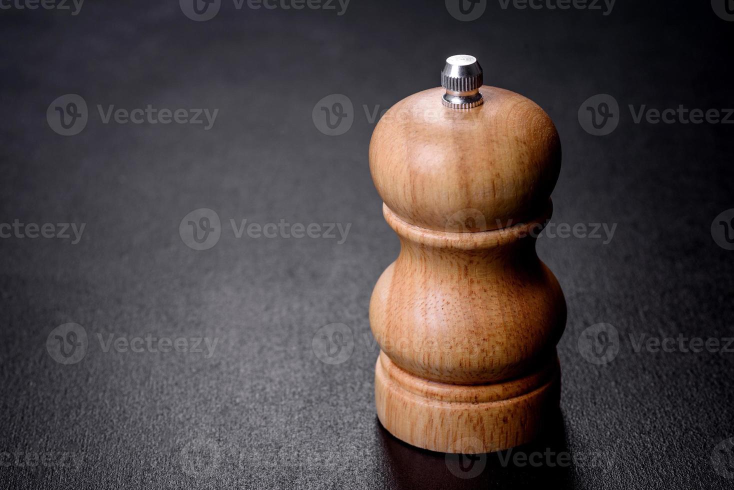 Salt or pepper shakers on black cncrete table. Space for text photo