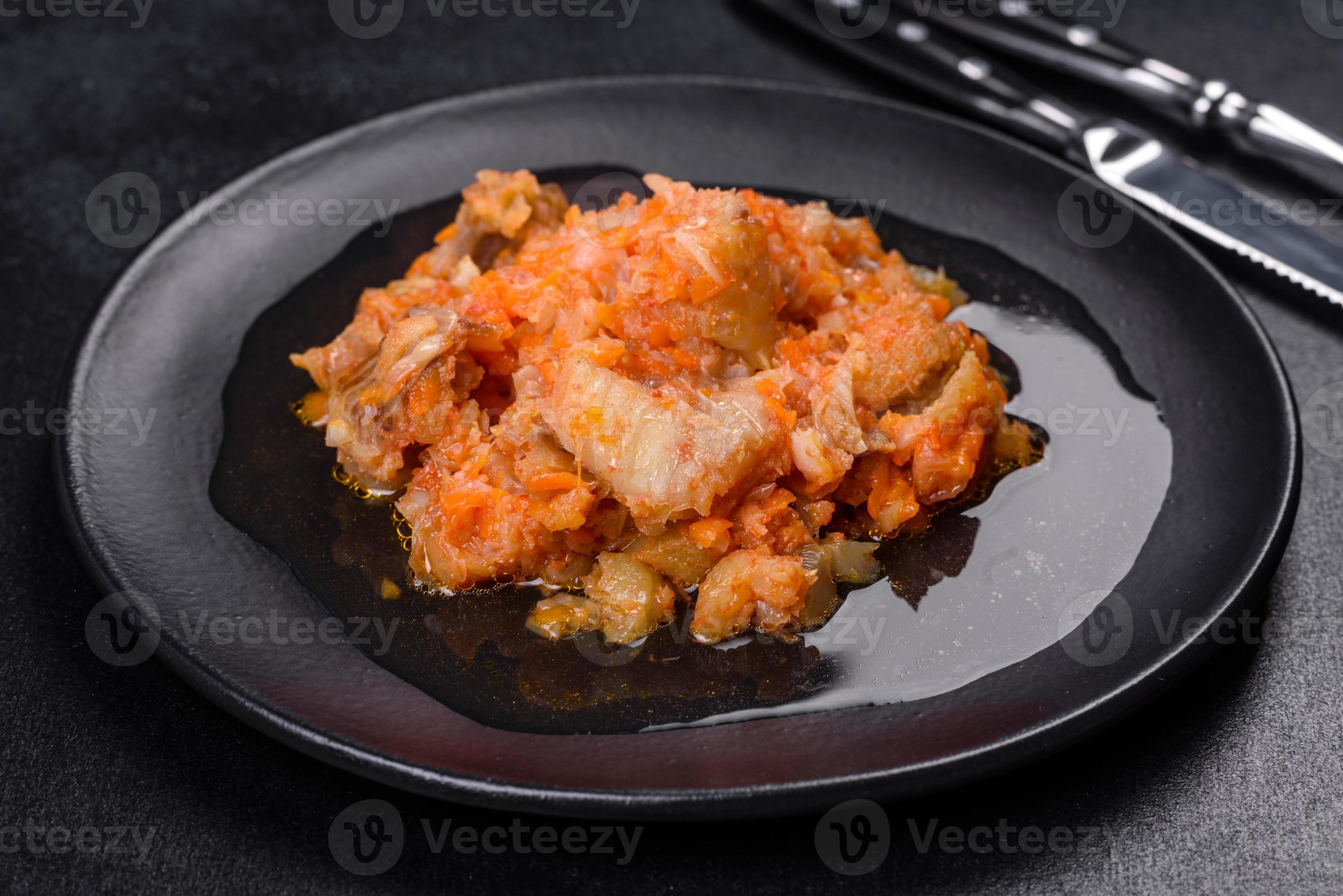 A delicious dish of hake fish in chunks in tomato sauce with spices and