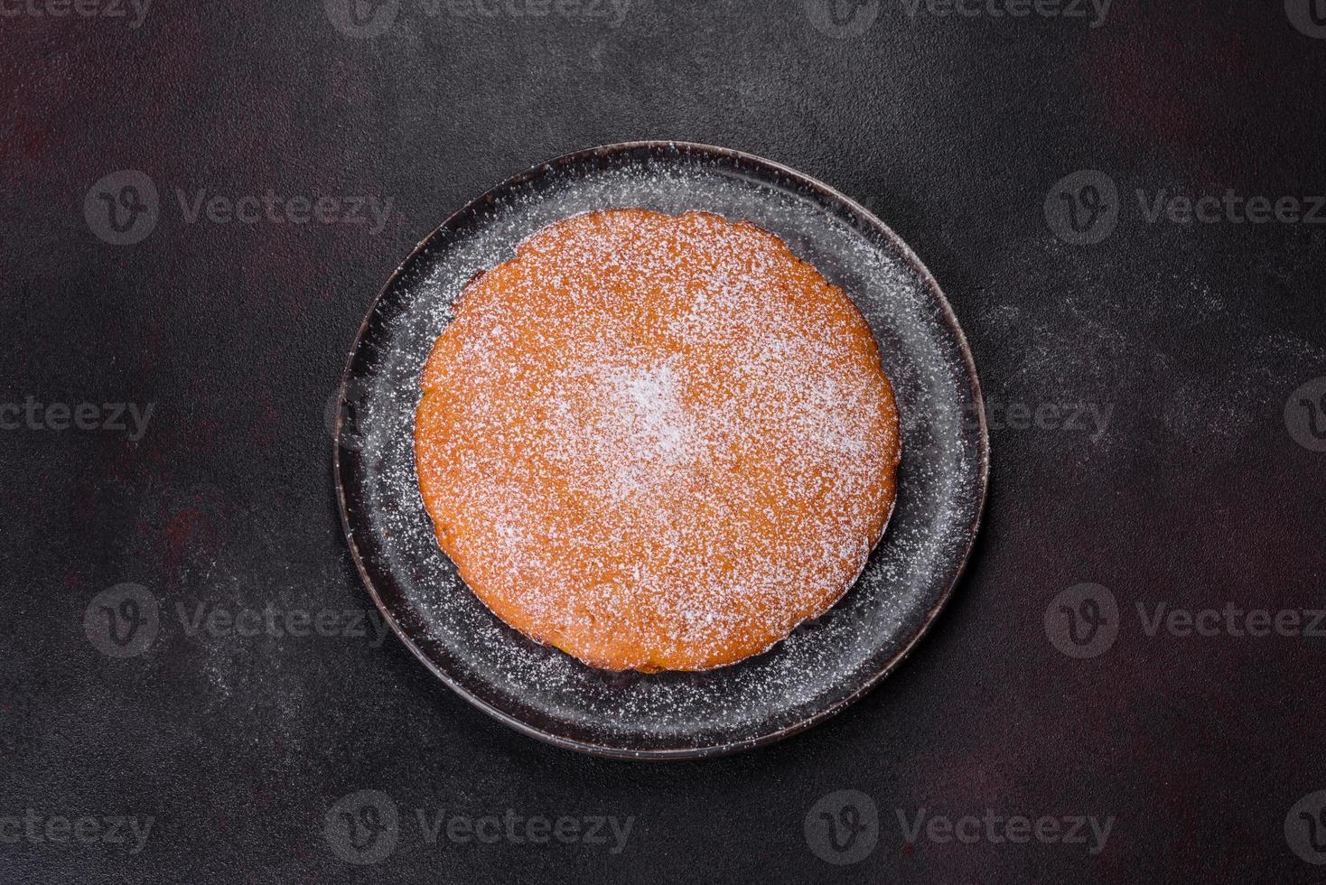 Pumpkin pie, tart made for Thanksgiving day with whipped cream on a black plate photo