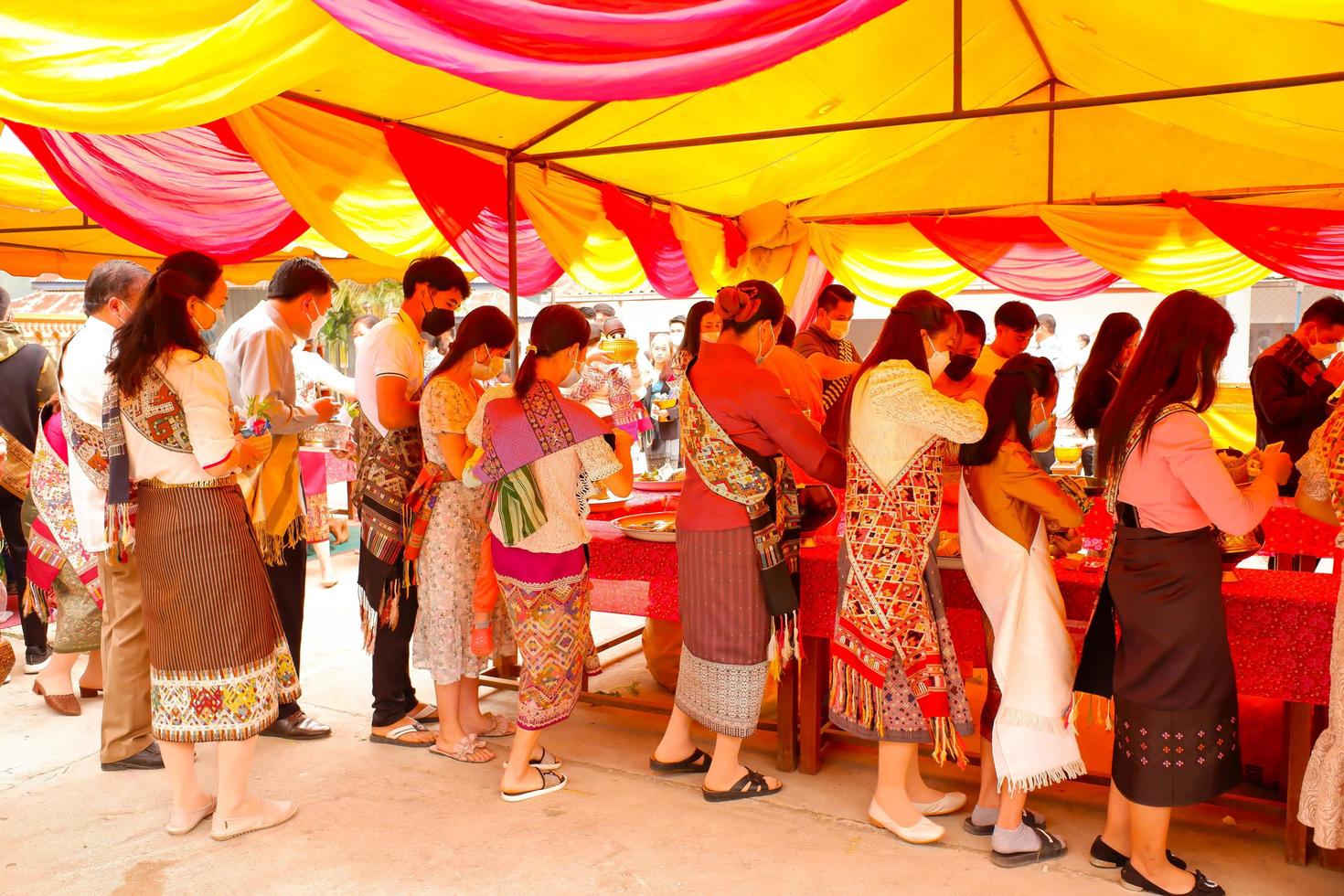 04.14.2022 Xamneua, Houaphanh, Laos. Laos Buddhist to do good things make merit by offer food to the monk. Lao new year or Song Kran. Concept inherit Lao culture. photo